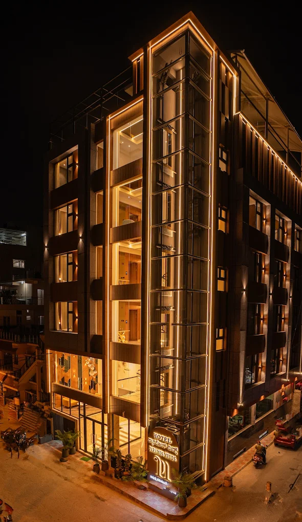 Hotel Paramos Meeds building in Madiwala, lit up at night